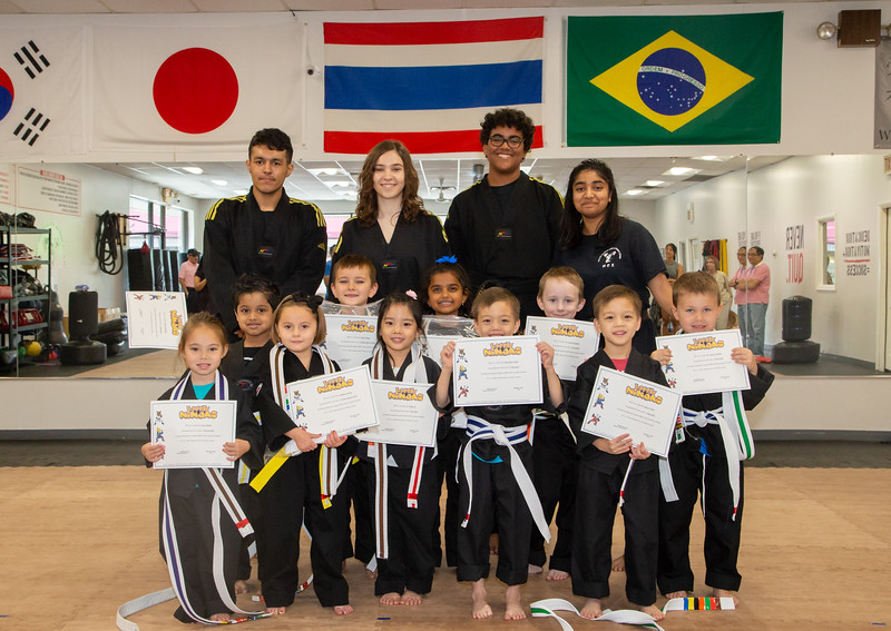 U.S. Elite Little Ninjas celebrating with their instructors and graduation certificates