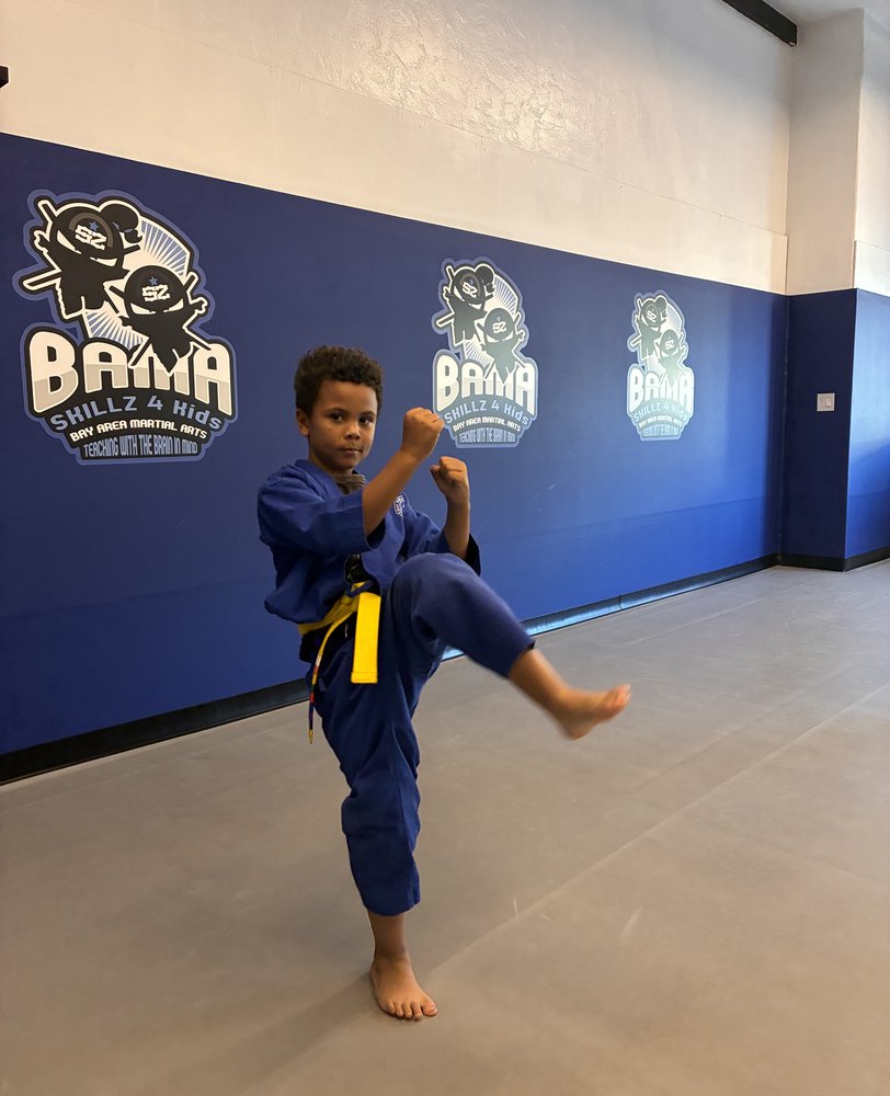 Young student practicing a knee raise in class at Bay Area Martial Arts in Oakland