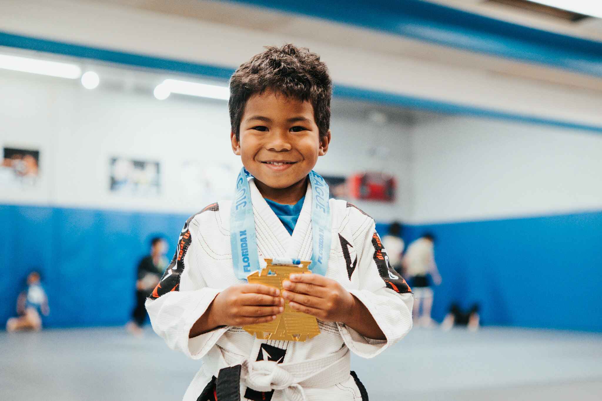 Kids BJJ student with medal at Fusion X-Cel