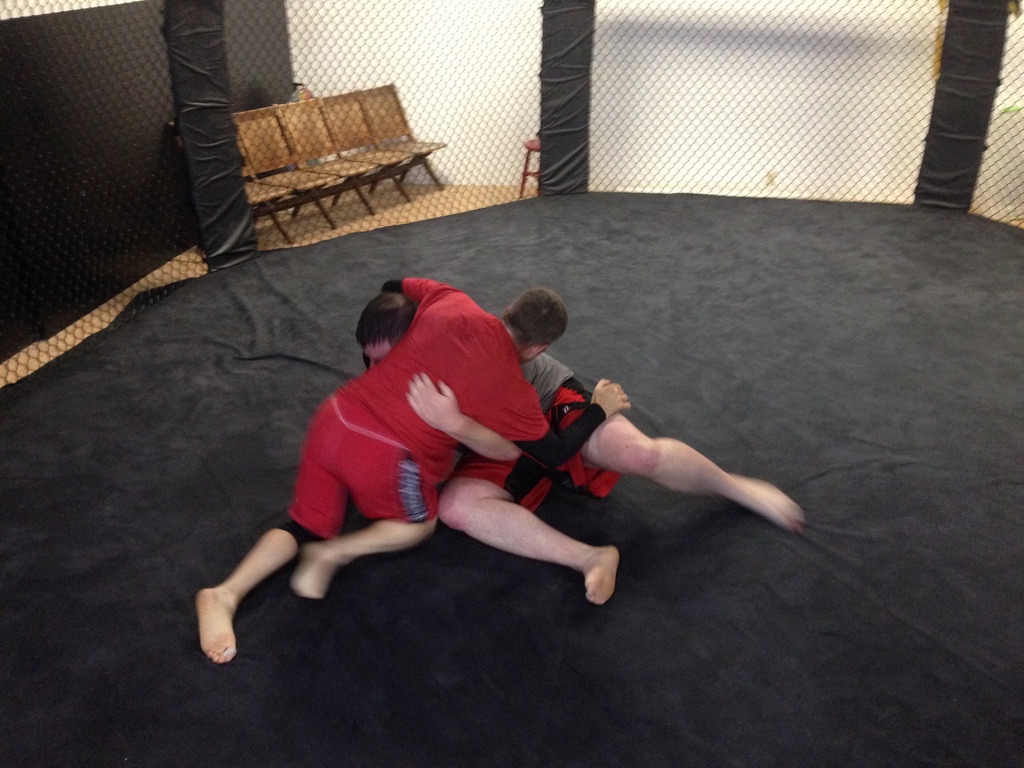 Will Crockan and John Payne grappling on the mat at Lauzon MMA