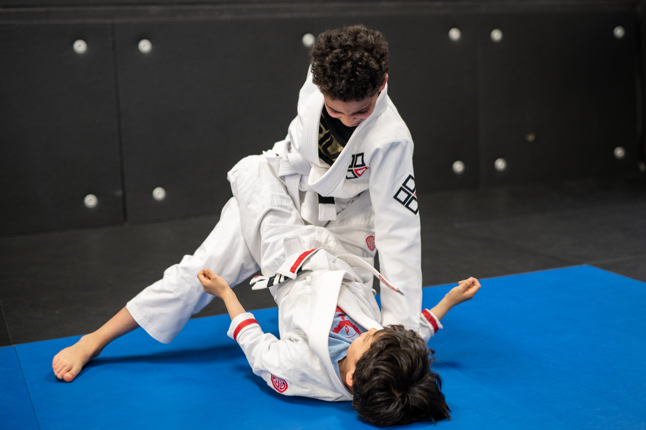 Older youth practice takedowns during Teen BJJ program.