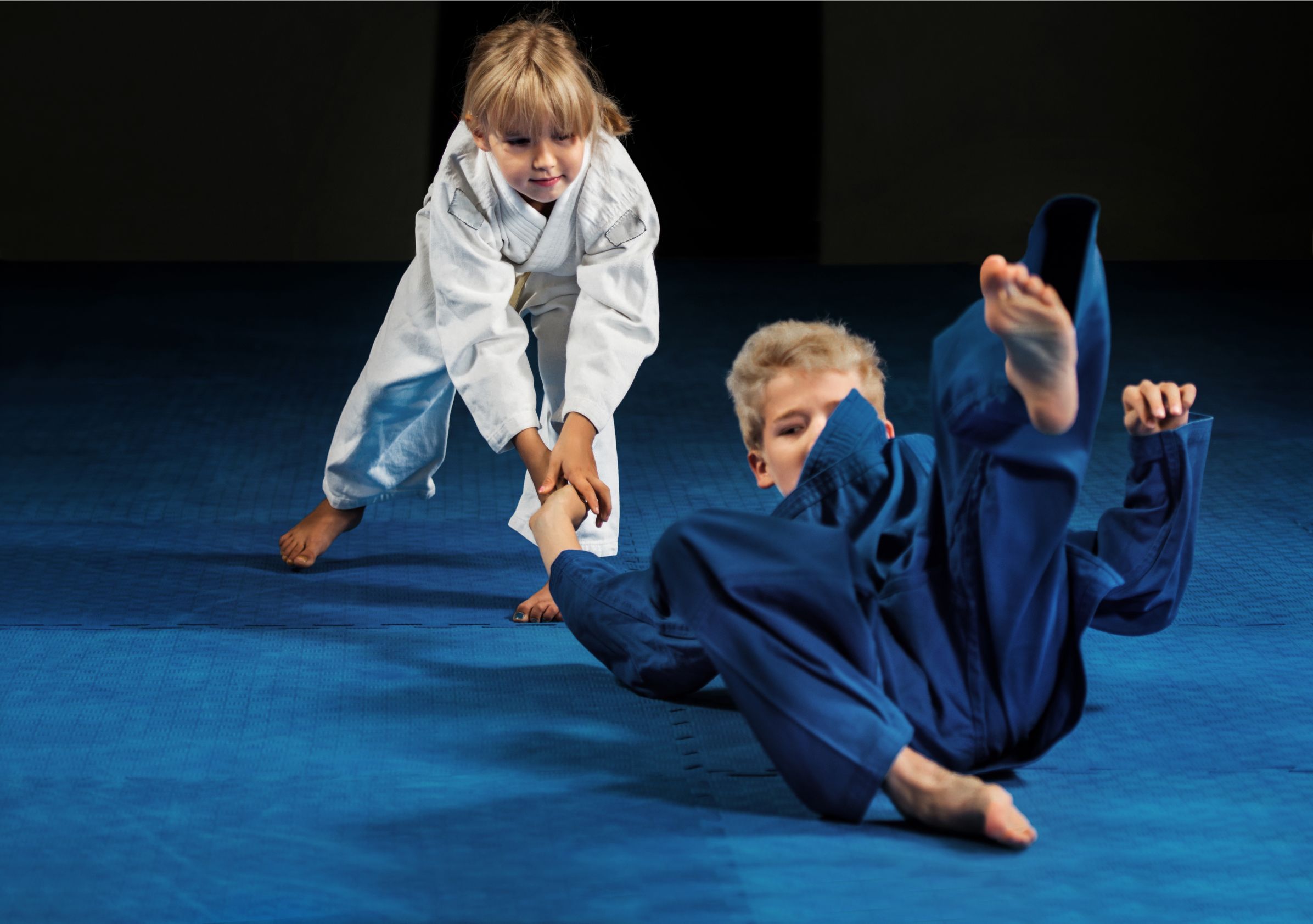 Youth practicing BJJ takedowns.